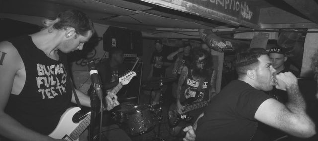 VILE INTENT title over a black and white photo of Vile Intent playing in a small basement