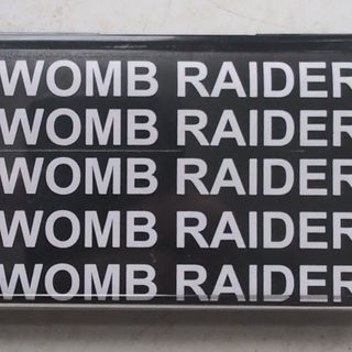 womb raider repeated in a bold font white on black